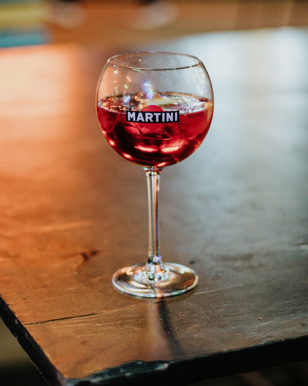 a close up of a wine glass on a table