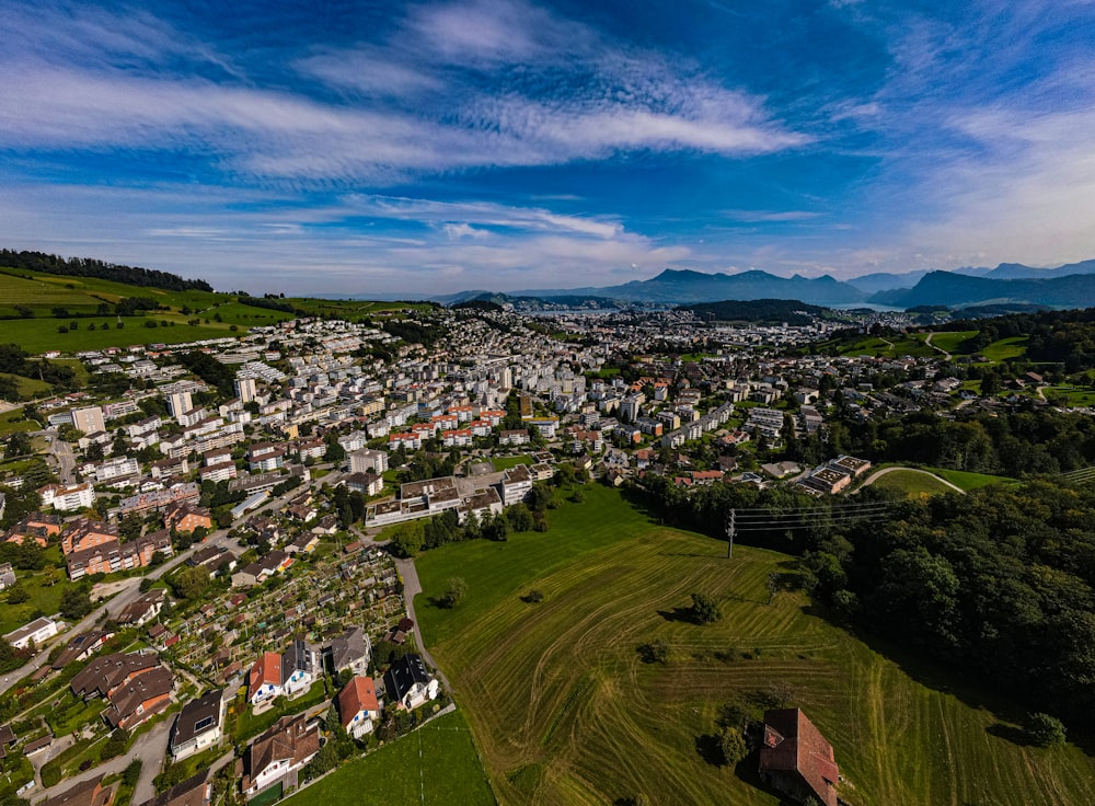 a bird's eye view of a city with mountains in the background