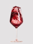 a wine glass filled with red liquid