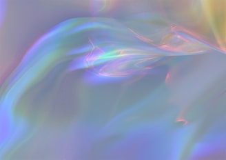 Soft, swirling patterns and gradients blend together in pastel hues of blue, purple, pink, and green, creating an ethereal and dreamy atmosphere.