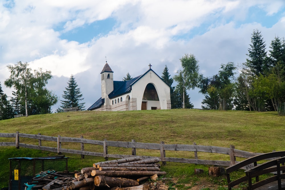 a church on a hill with a fence around it