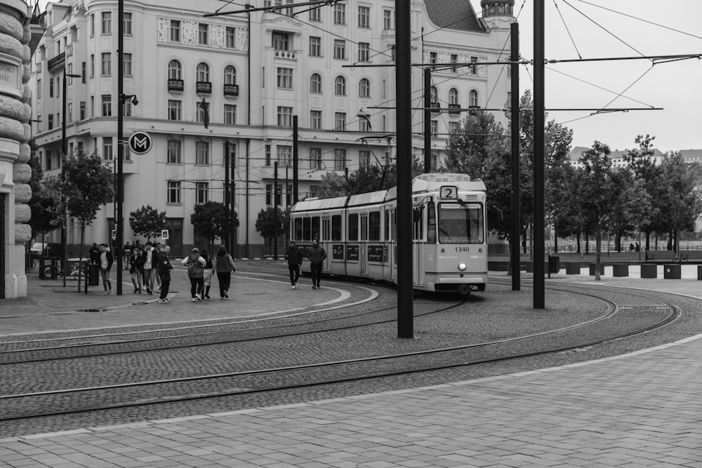 a black and white photo of a bus on a city street