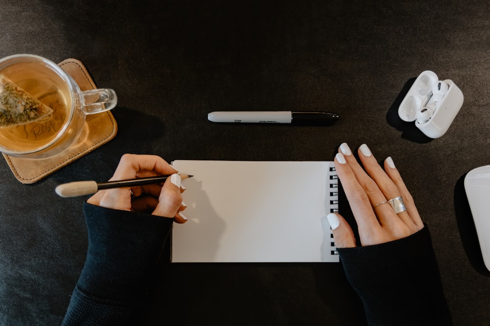 a person writing on a piece of paper