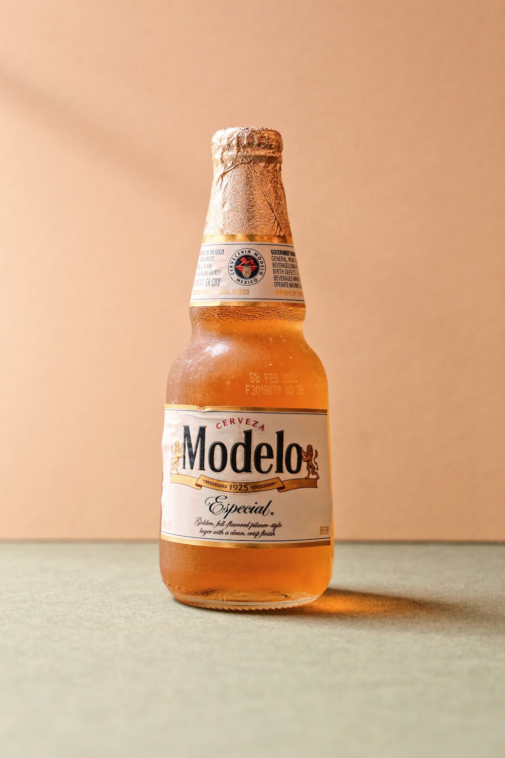 a bottle of modelo beer sitting on a table photo – Free Beer Image on  Unsplash