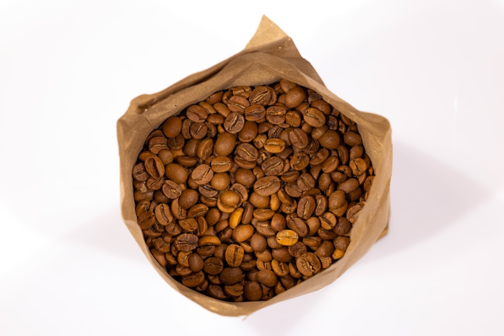 a bag full of coffee beans on a white background