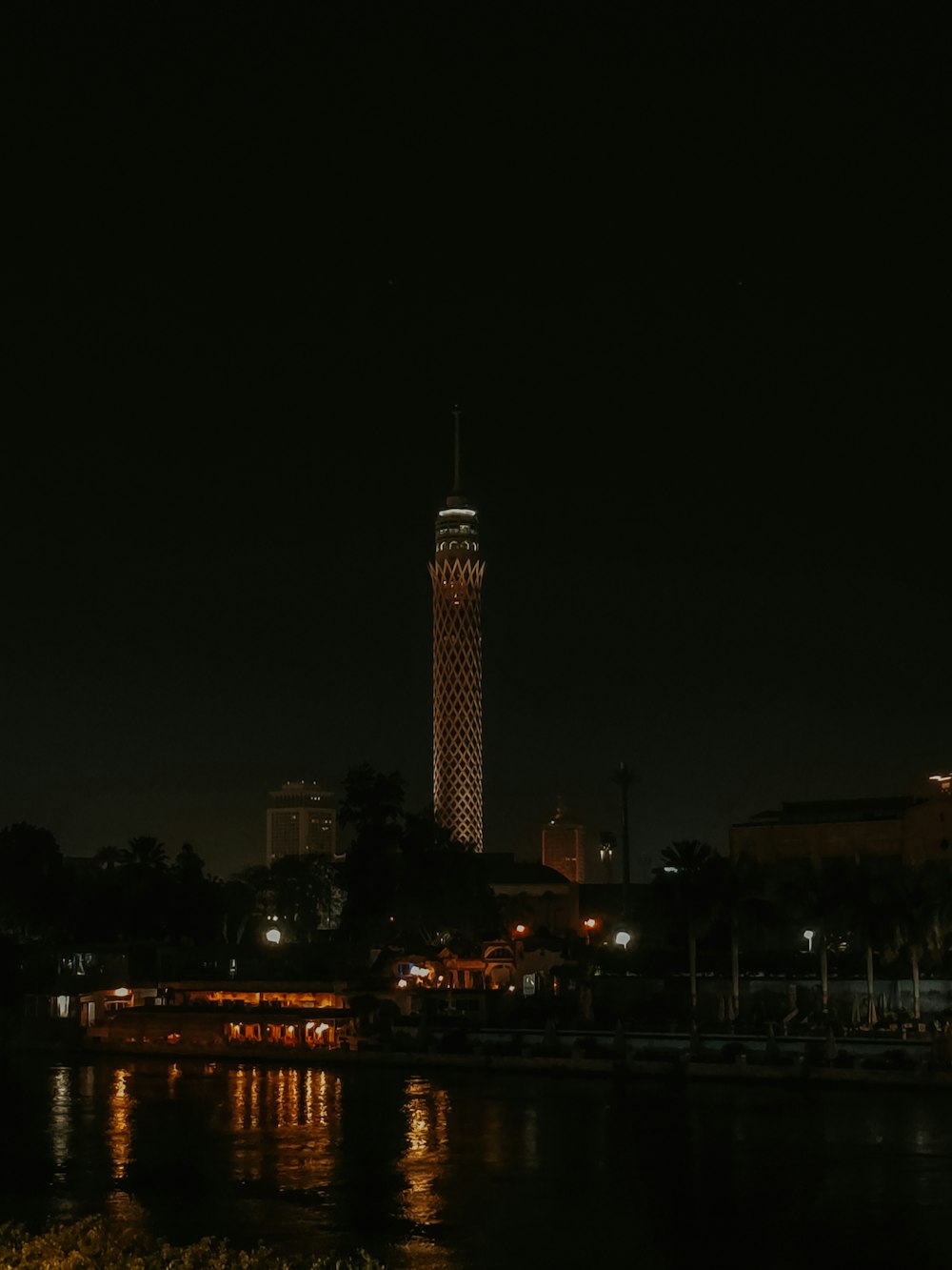 a night view of a city with a clock tower in the background