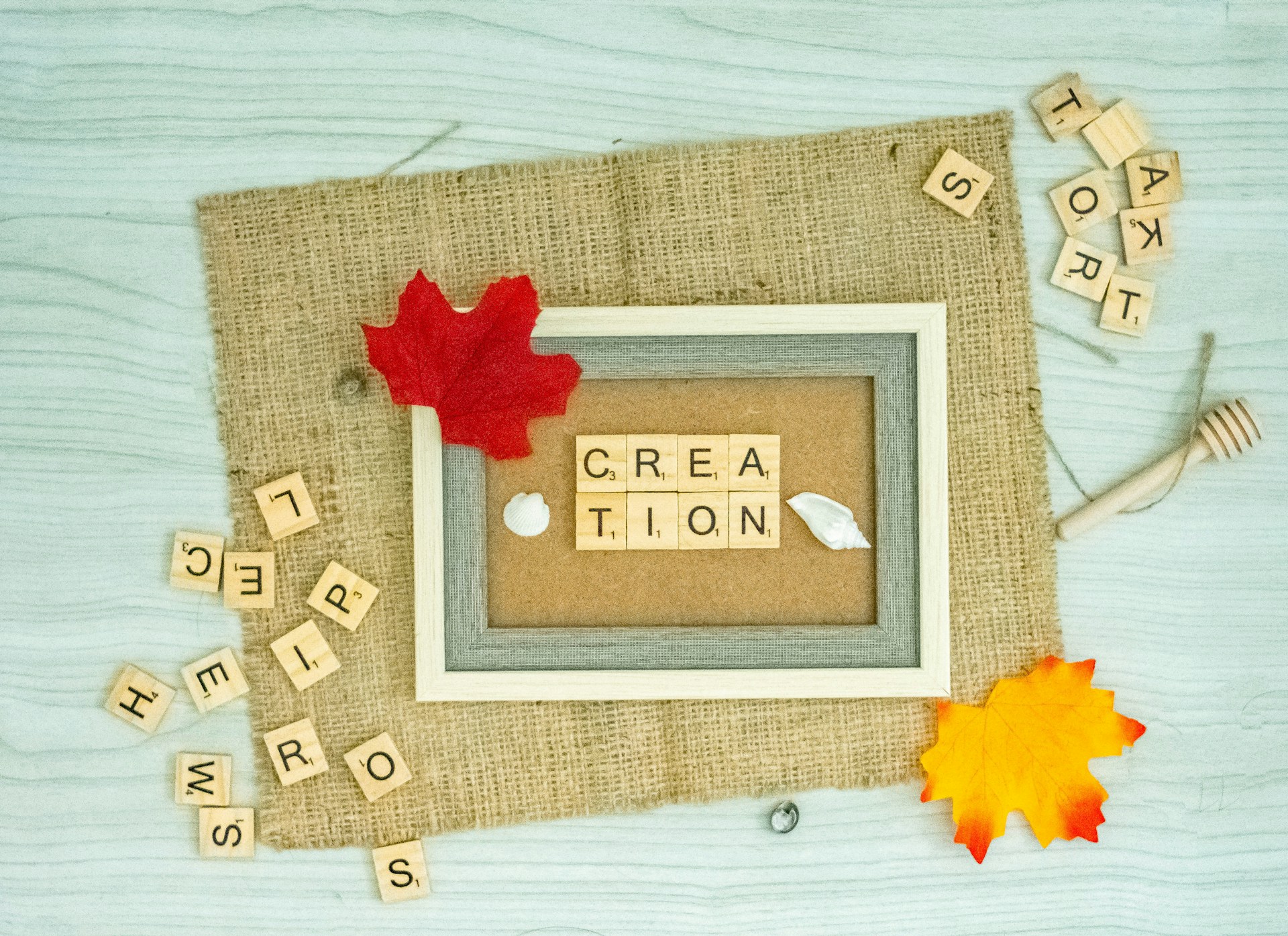 a picture frame with the word creation spelled in scrabble letters