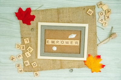 a picture frame with the word emporer spelled in scrabble