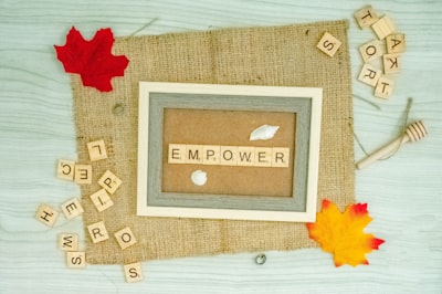 a picture frame with the word emporer spelled in scrabble