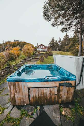 a hot tub sitting on top of a stone walkway