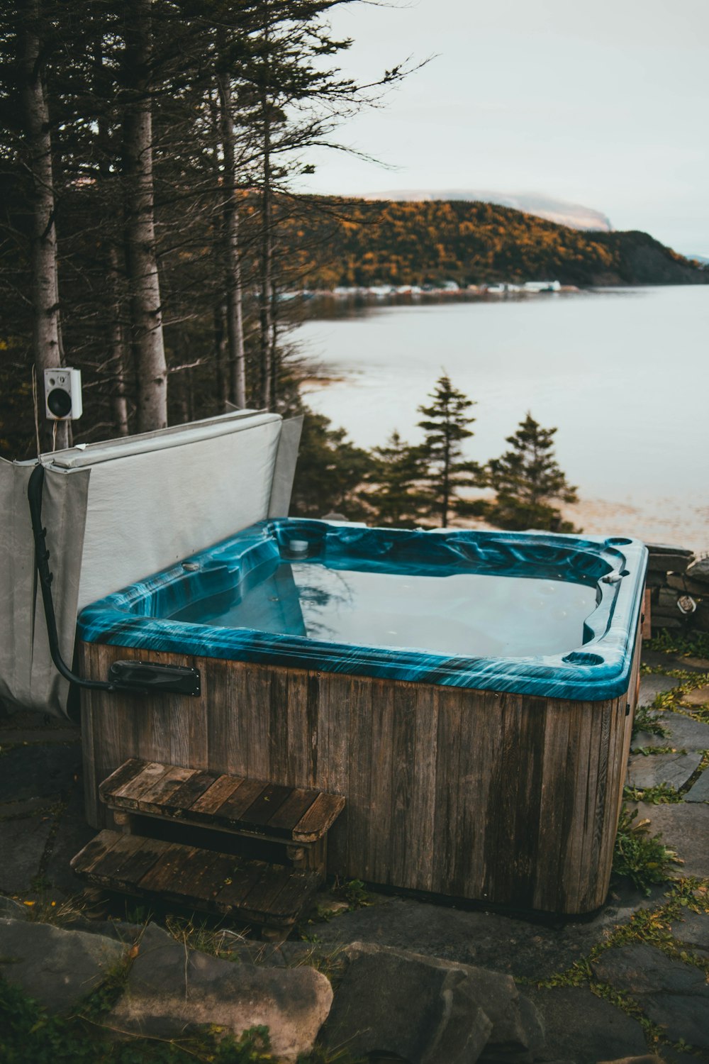 a hot tub sitting next to a body of water