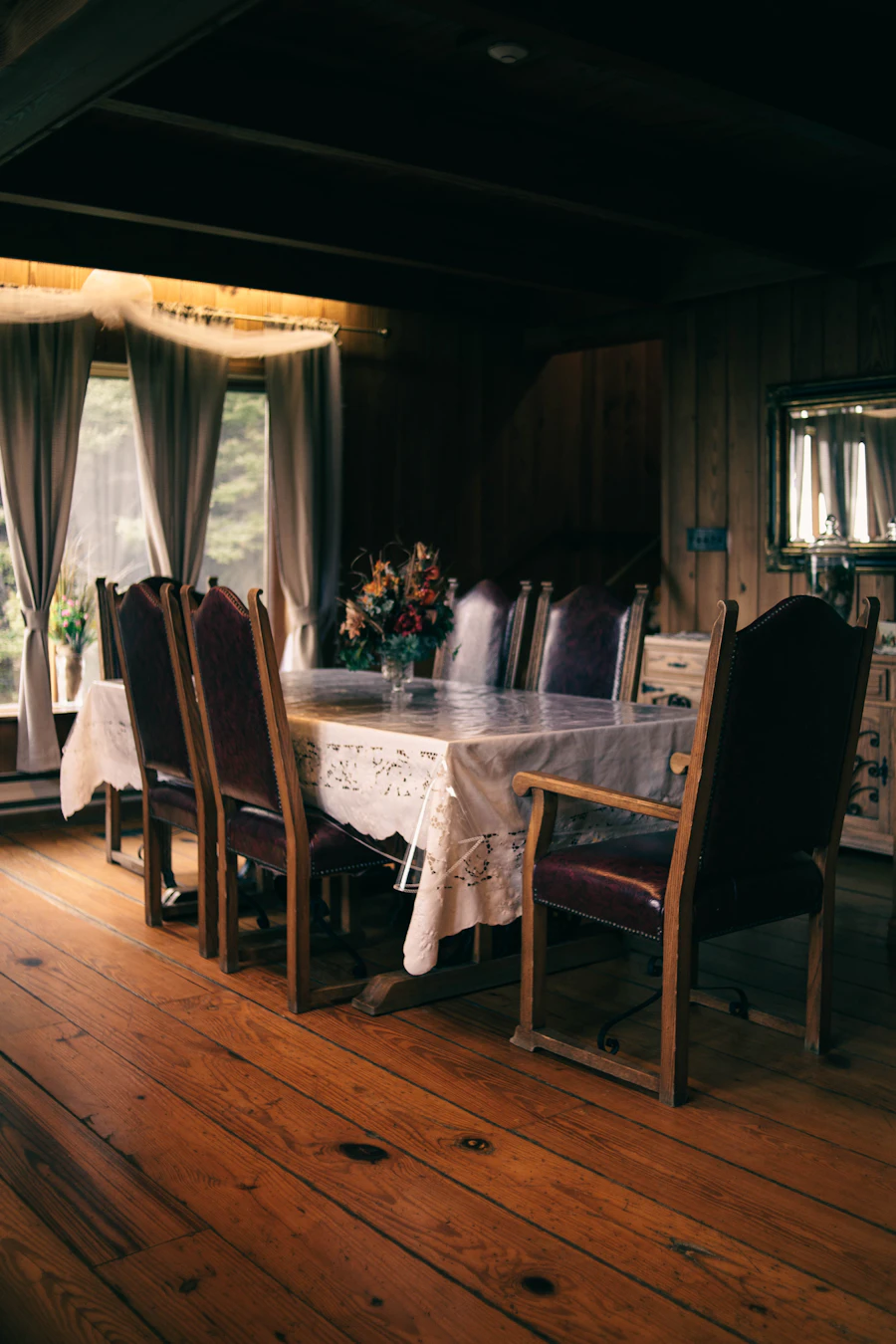 Dining room with a wooden table and warm layered lighting