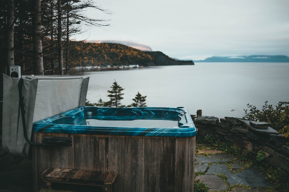 a hot tub sitting next to a body of water