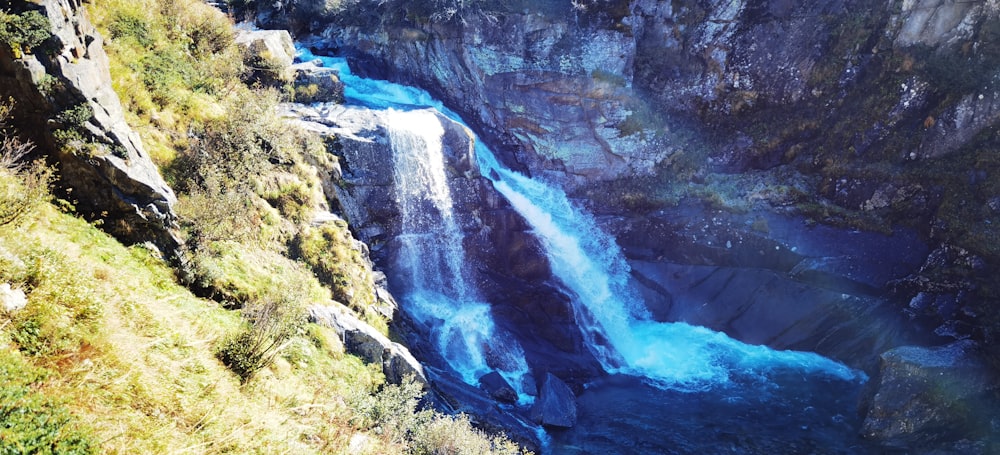 a waterfall with a rainbow in the middle of it