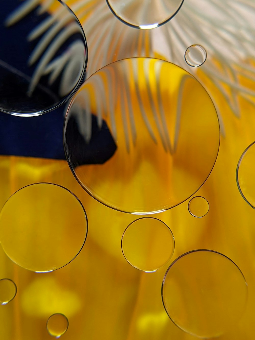 a close up of a yellow vase with bubbles