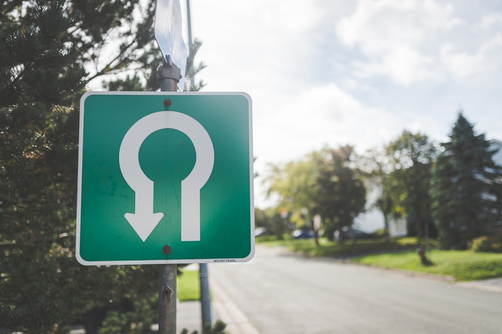 a green sign with an arrow pointing to the right