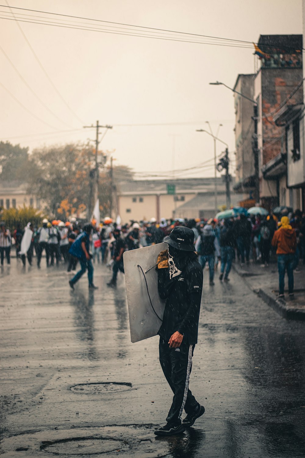 a man with an umbrella walking in the rain