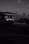 a black and white photo of a bus and cars