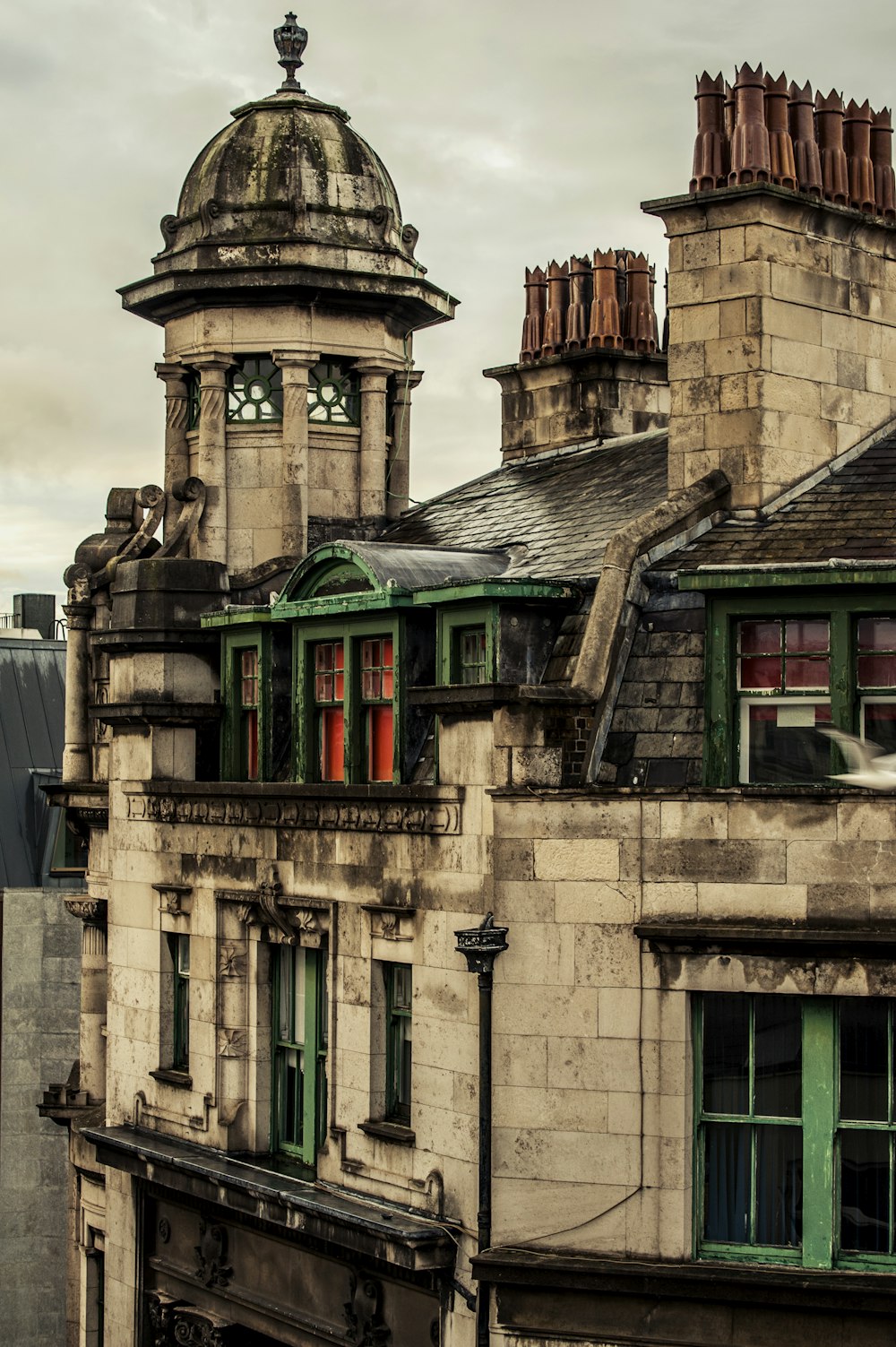 an old building with a clock on the top of it