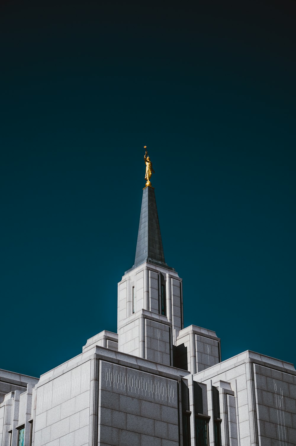 a church steeple with a gold statue on top