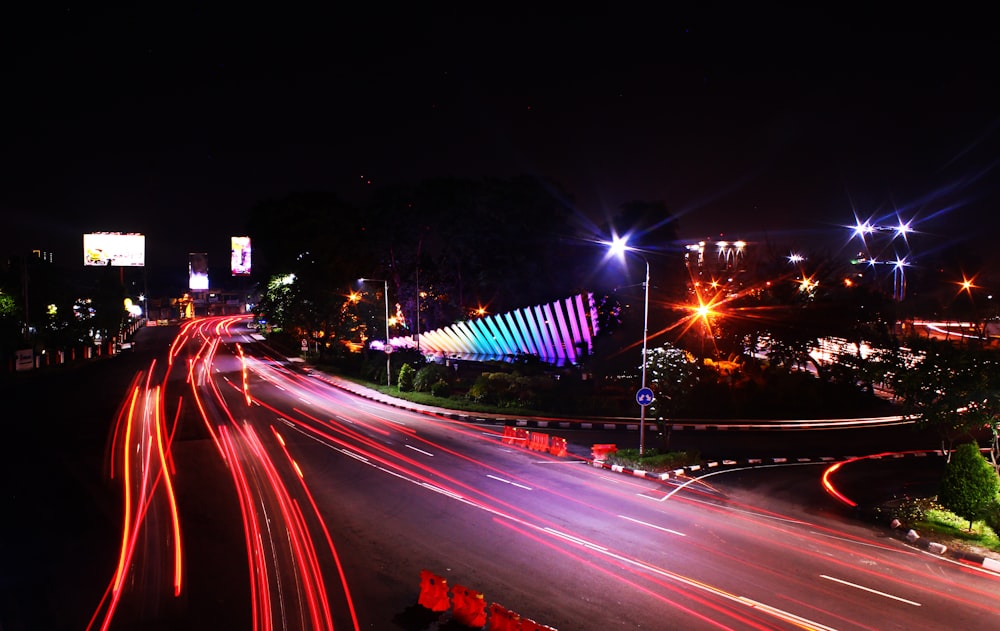 a city street filled with lots of traffic at night