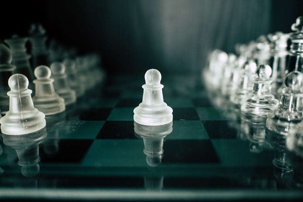 a black and white chess board with white pieces