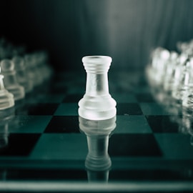 a black and white chess board with a white pawn