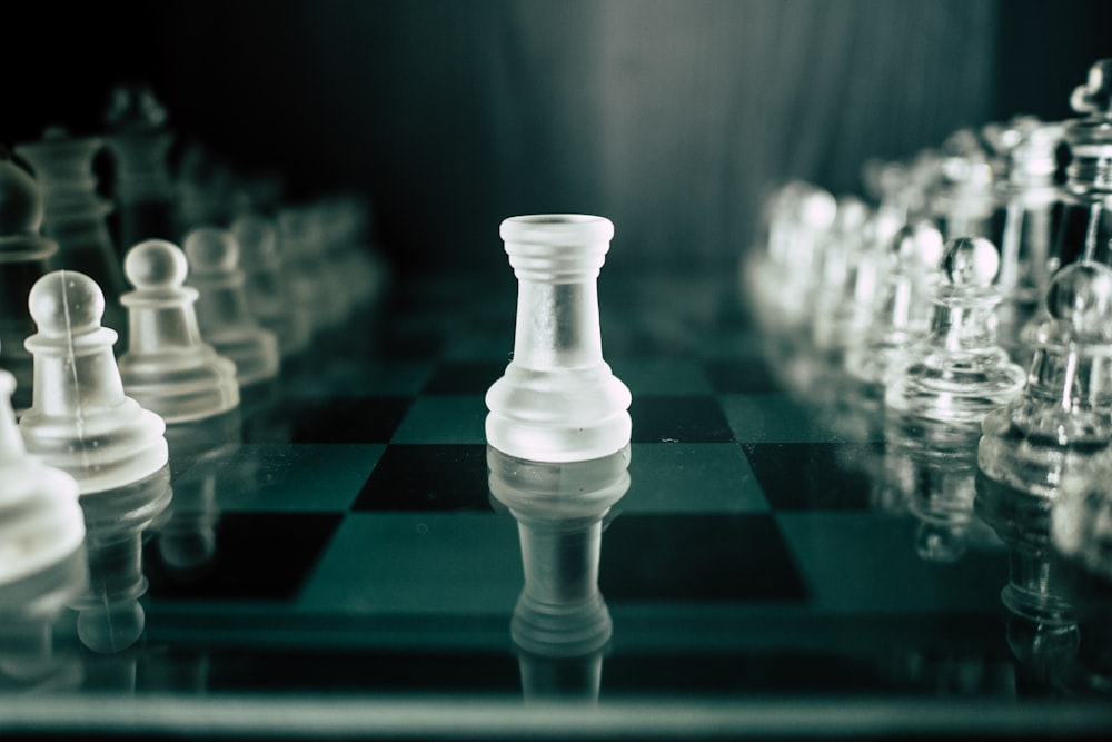 a black and white chess board with a white pawn