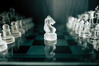 a glass chess board with a white horse on it