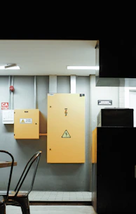 a table and chairs in a room with a yellow cabinet