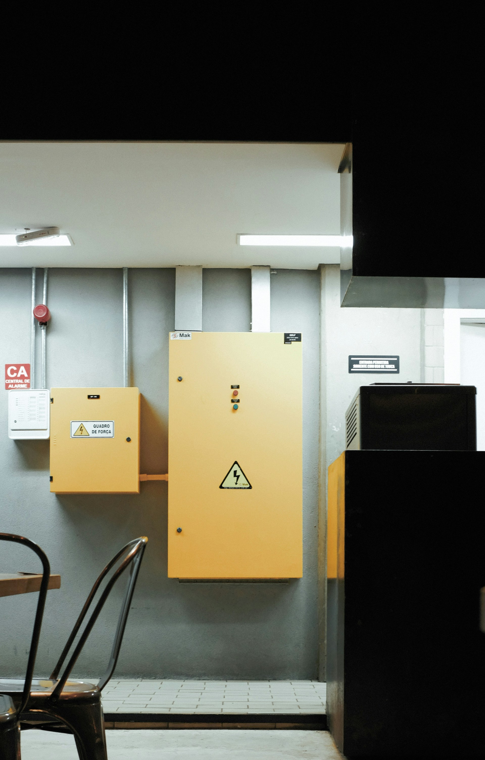 a table and chairs in a room with a yellow cabinet