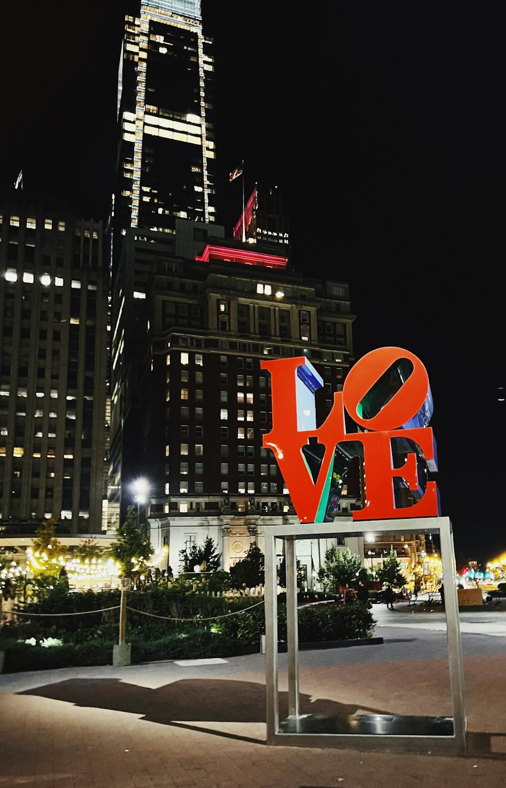 a large love sign in front of a tall building