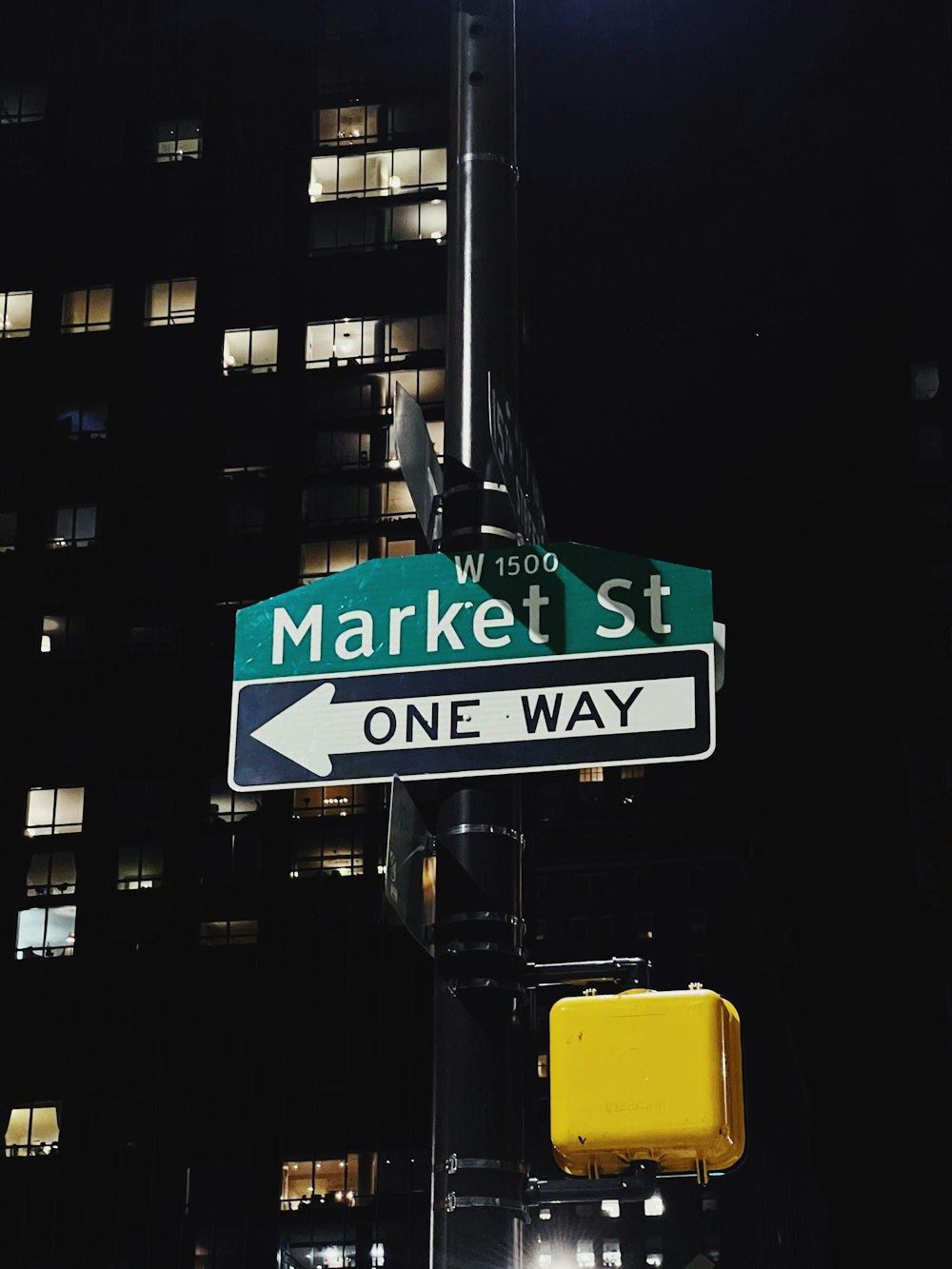 a street sign on a pole in front of a building