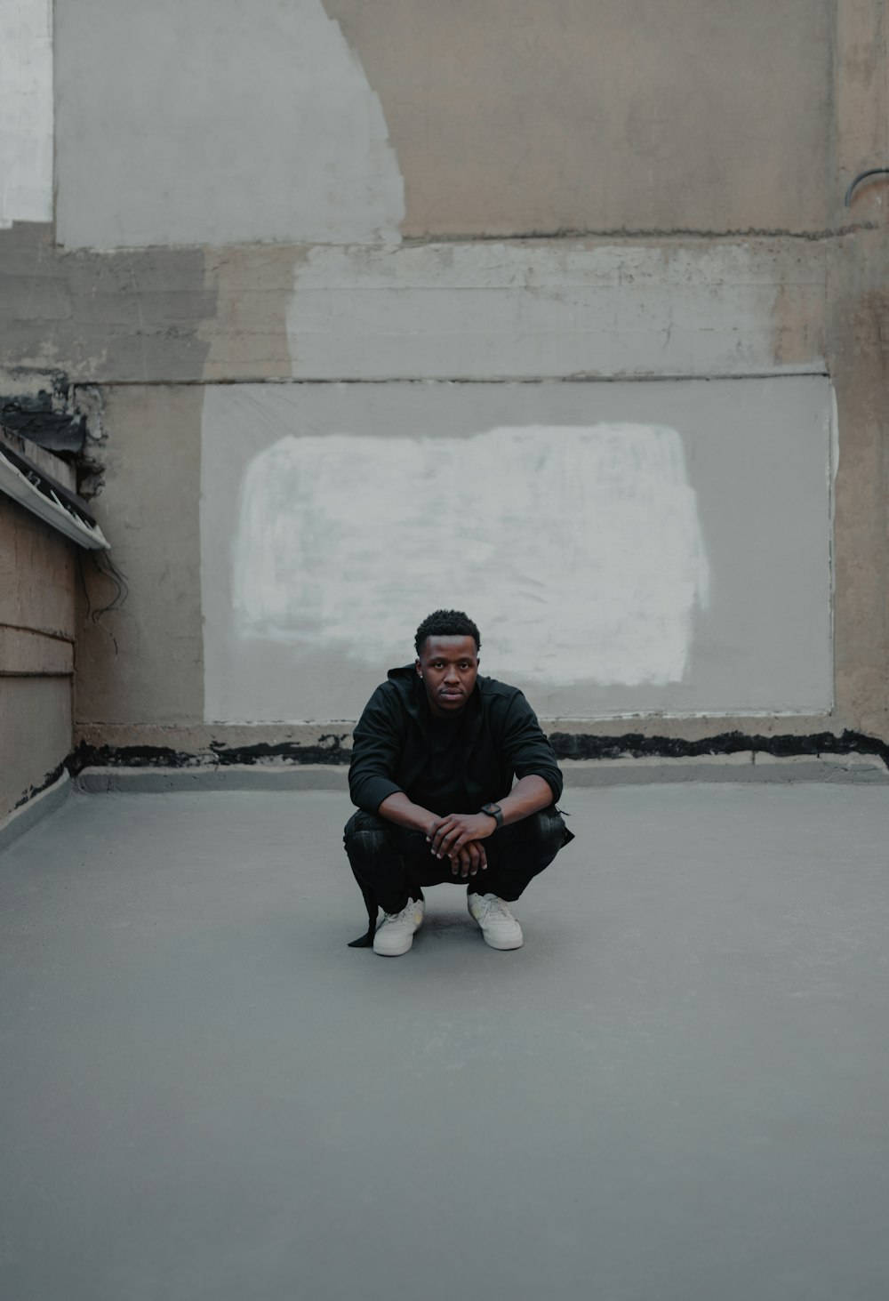 a man sitting on the ground in a room