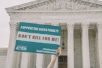 John Quinn of Democrats for Life of America holds a sign in front of the Supreme Court in Washington, DC, calling on the justices to choose mercy for Dzhokhar Tsarnaev, the Boston Marathon Bomber.