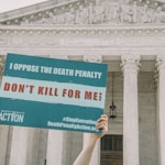 John Quinn of Democrats for Life of America holds a sign in front of the Supreme Court in Washington, DC, calling on the justices to choose mercy for Dzhokhar Tsarnaev, the Boston Marathon Bomber.