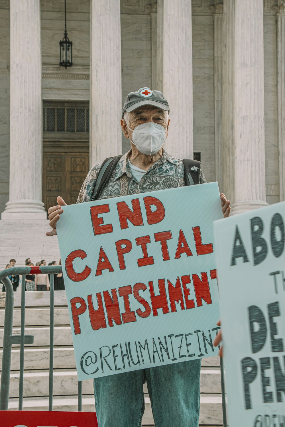 a man holding a sign in front of a building