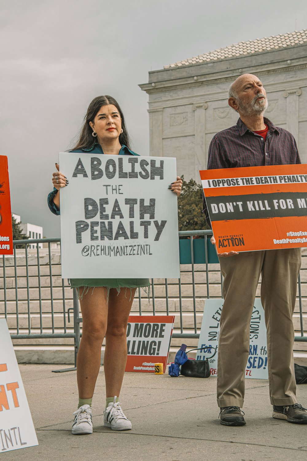 a group of people holding signs on the street