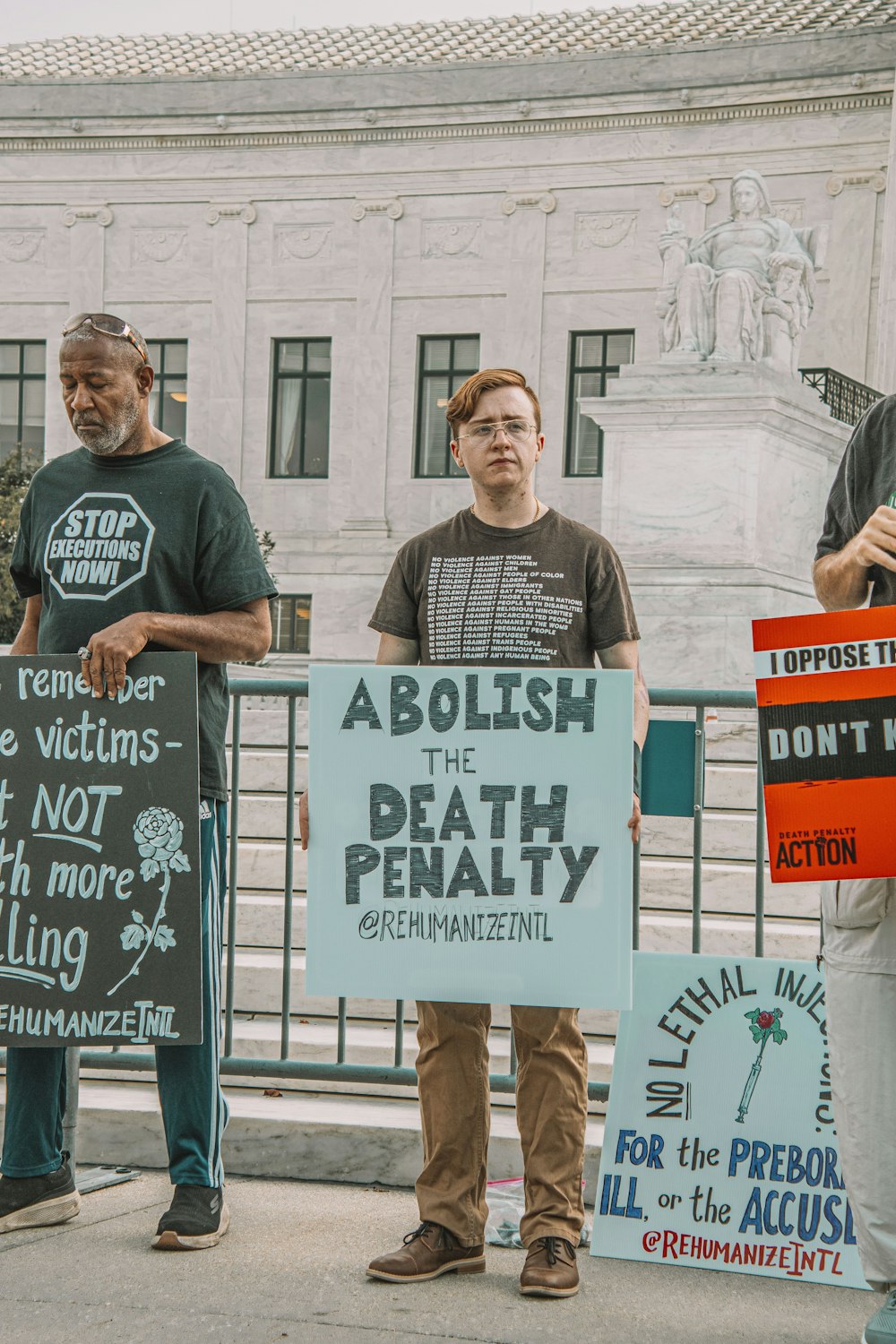 a group of people holding protest signs in front of a building