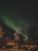 Exclusive property exterior glowing under a twilight sky with northern lights.
