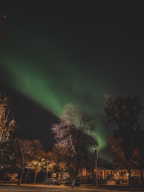 Exclusive property exterior glowing under a twilight sky with northern lights.