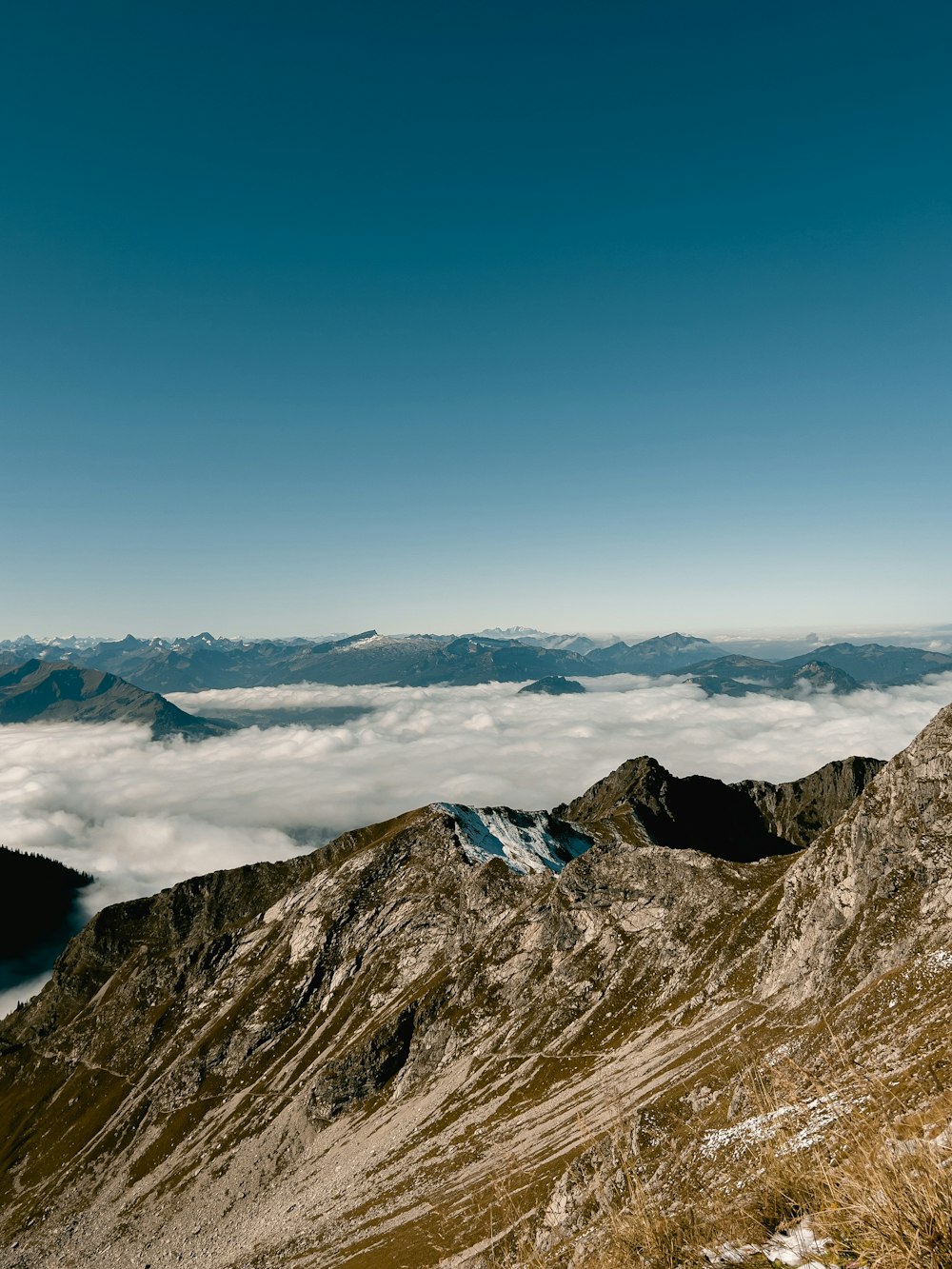 a view of a mountain range with low lying clouds