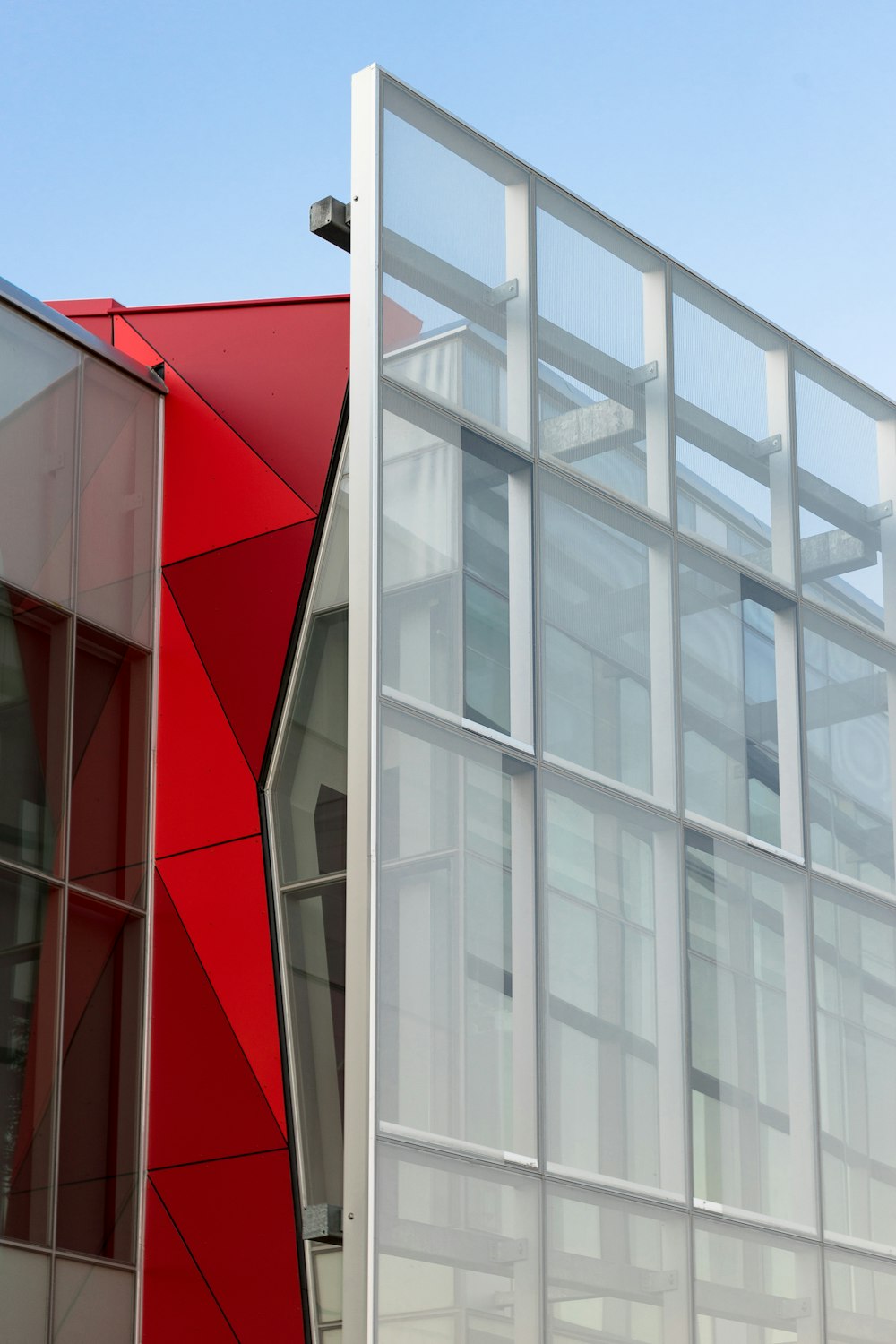 a red and white building with a clock on it's side