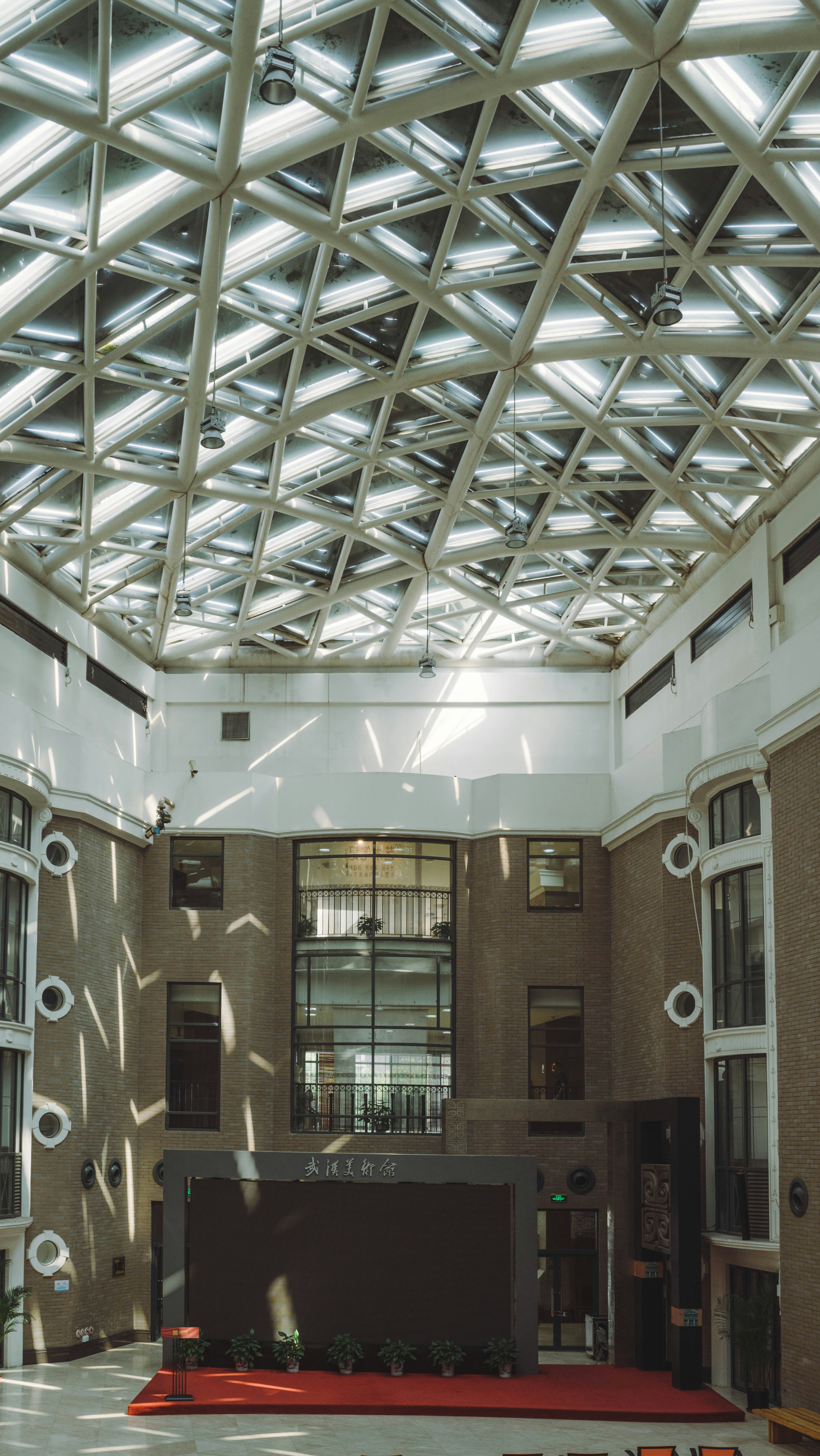 a large room with a ceiling made of metal beams