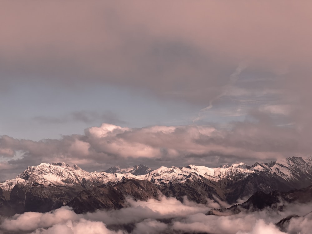 a view of a mountain range covered in clouds