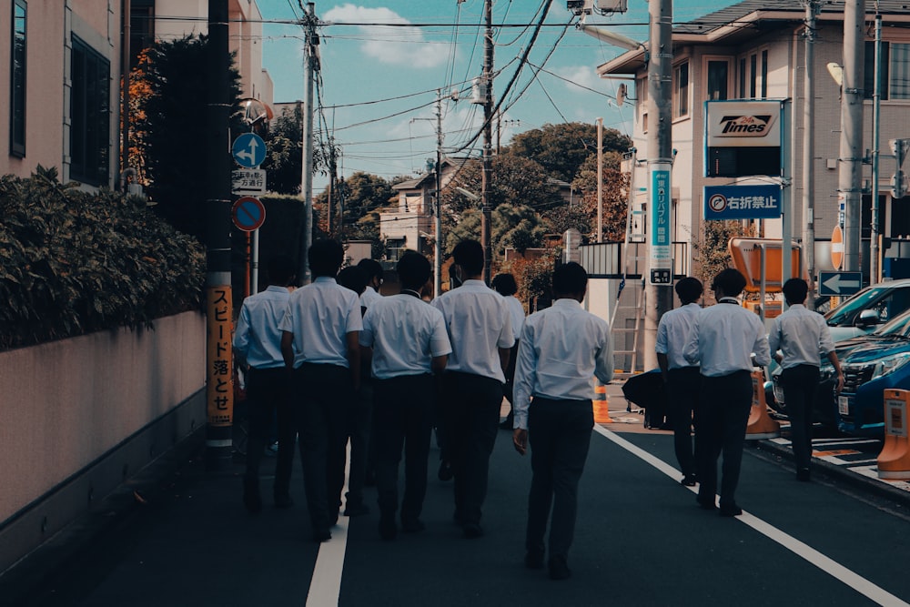 a group of men walking down a street