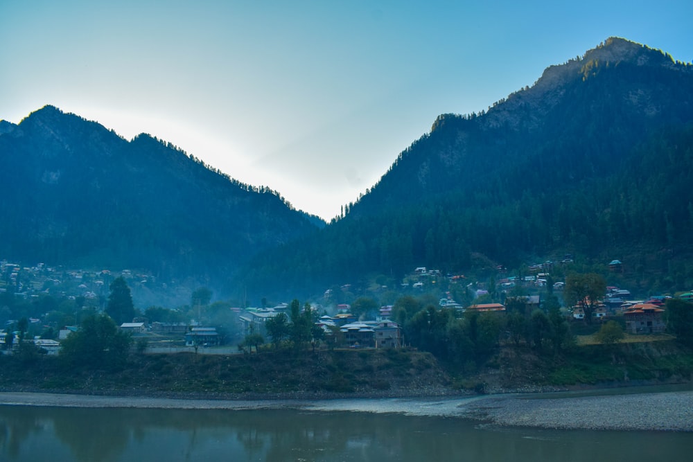 a view of a town and mountains from a river