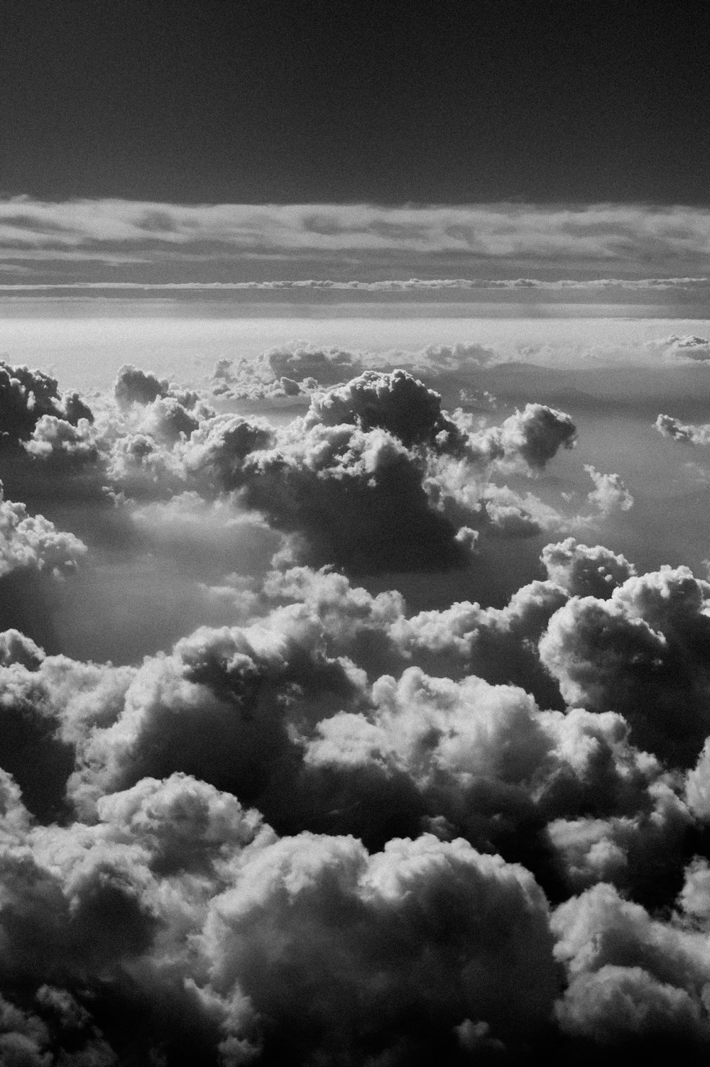 a black and white photo of clouds in the sky