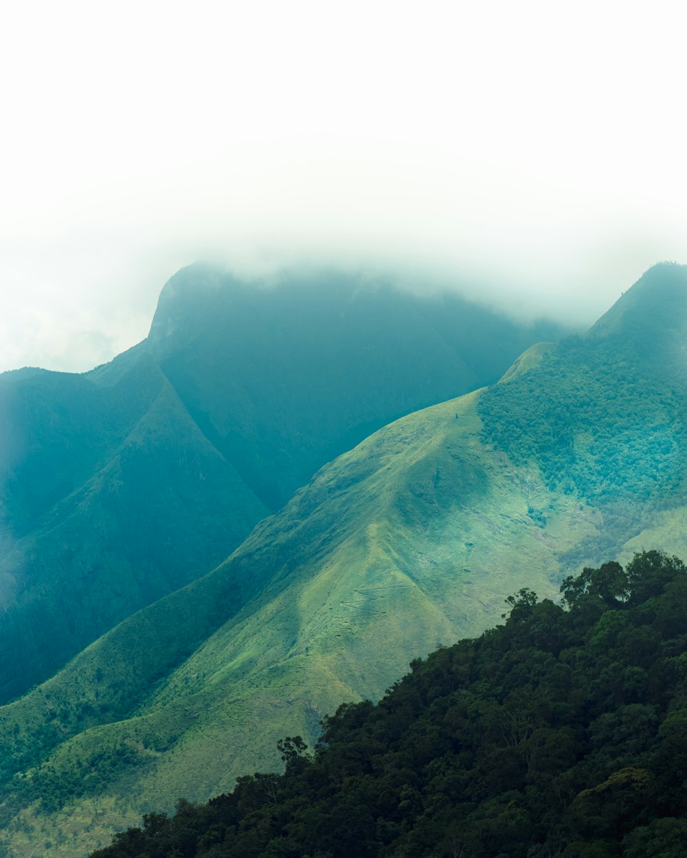 a view of a mountain range with a few clouds