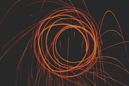 an orange spiral is shown against a black background